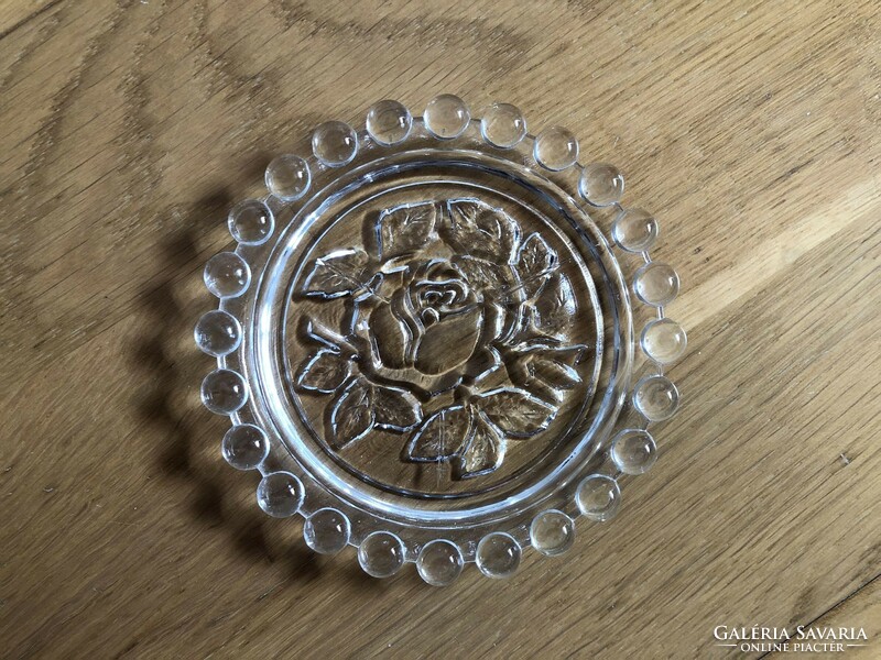 Rose flower in small glass plate, ashtray?