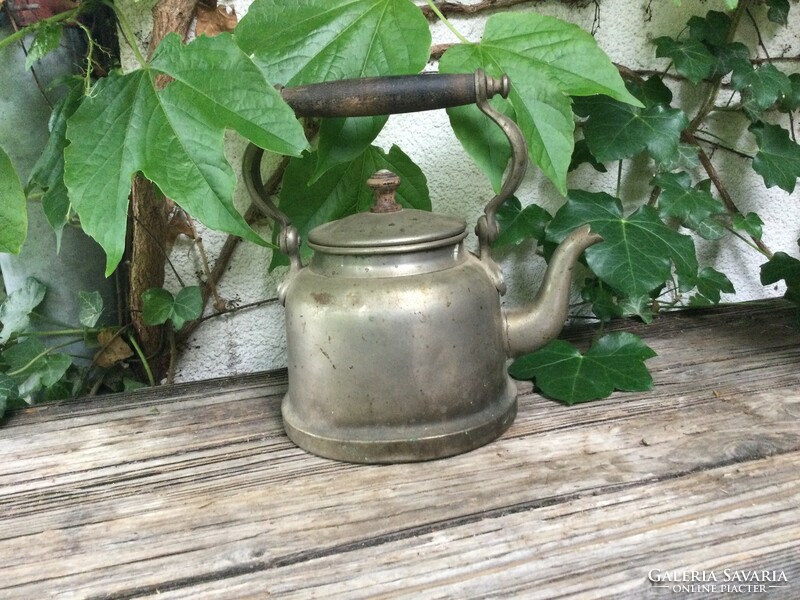 Old teapot with wooden tongs