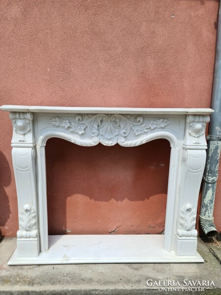 White marble fireplace with floral decoration