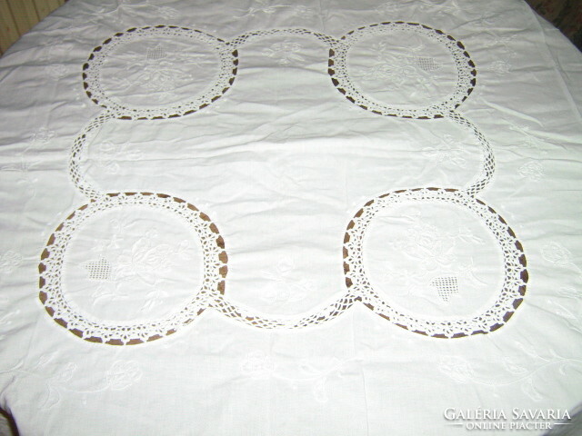 A dreamy white embroidered tablecloth with a hand-crochet insert