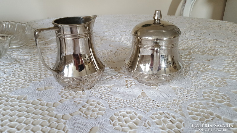 Silver-colored pewter sugar bowl with lid and milk and cream jug