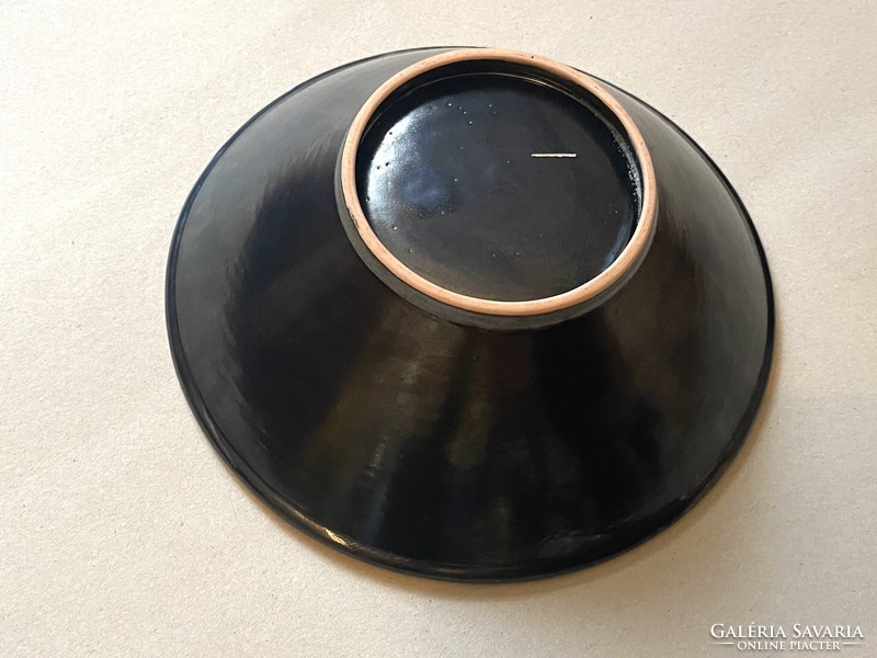 Retro ceramic bowl centerpiece with black geometric painting on an orange base