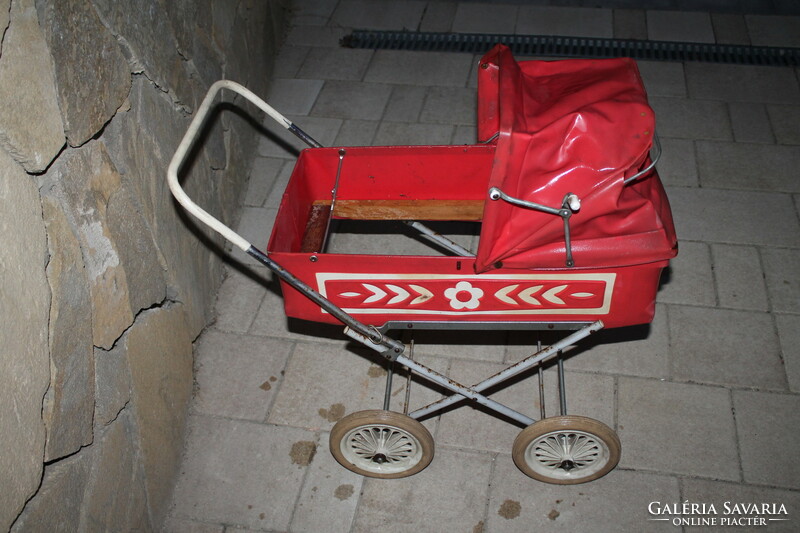 Old retro stroller in red color.