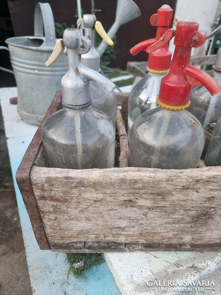 Old soda bottles with a worn case.
