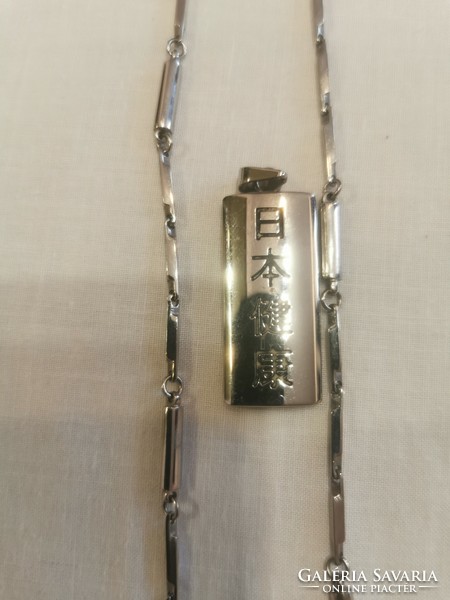 Necklace with medicinal nikken and a hozza pendant