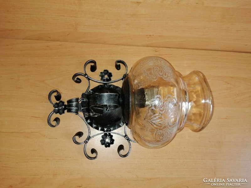 Wrought iron wall lamp with glass shade