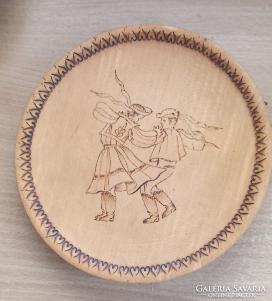 Wooden plate (2) pyrographed with folk motifs.