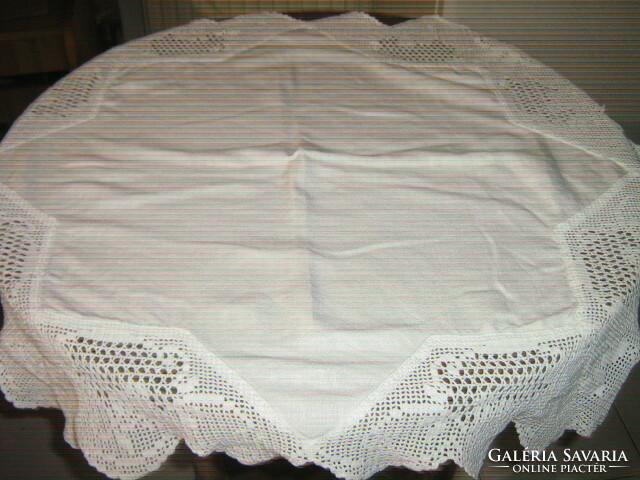 A beautiful star-shaped tablecloth with a crocheted edge with a floral pattern