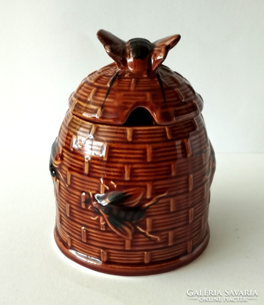 A majolica honey dispenser in the shape of a beehive