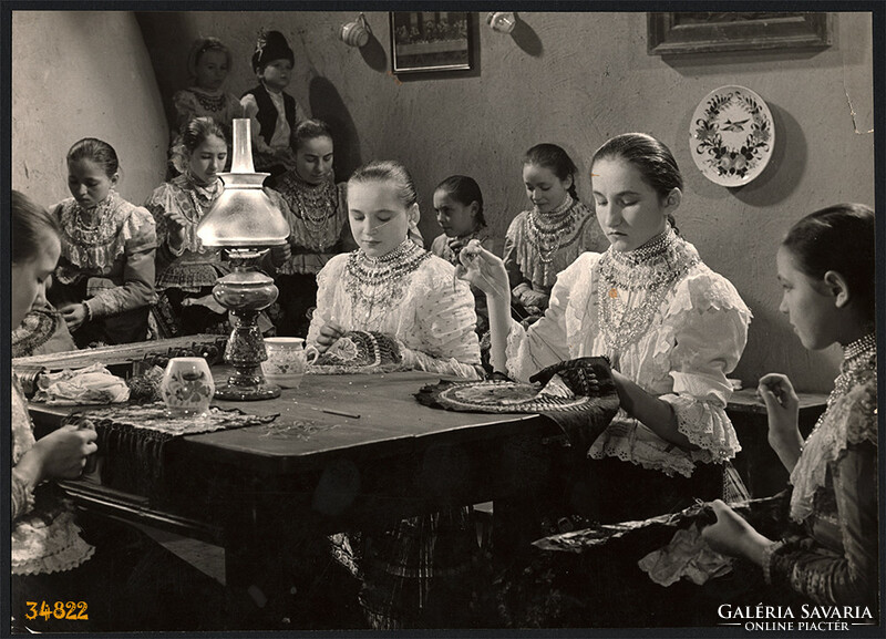 Larger size, photo art work by István Szendrő. Girls around the table in national costume, embroidery k