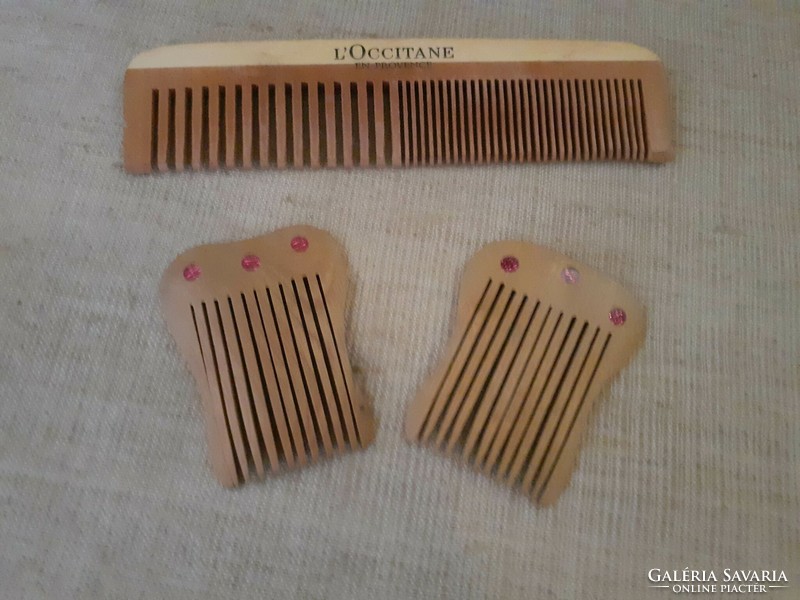 A wooden comb in good condition with two matching small wooden hair combs studded with stones