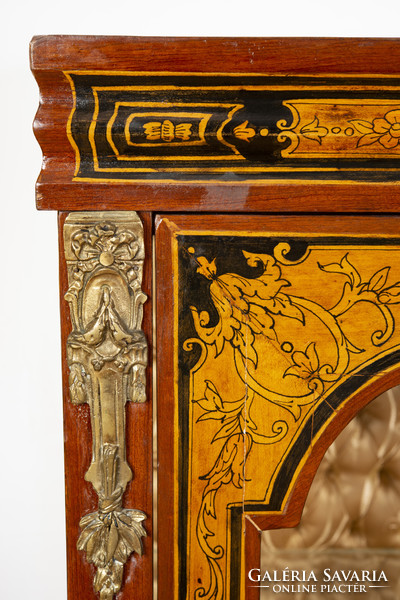 Showcase with gilded edges and intarsia decoration
