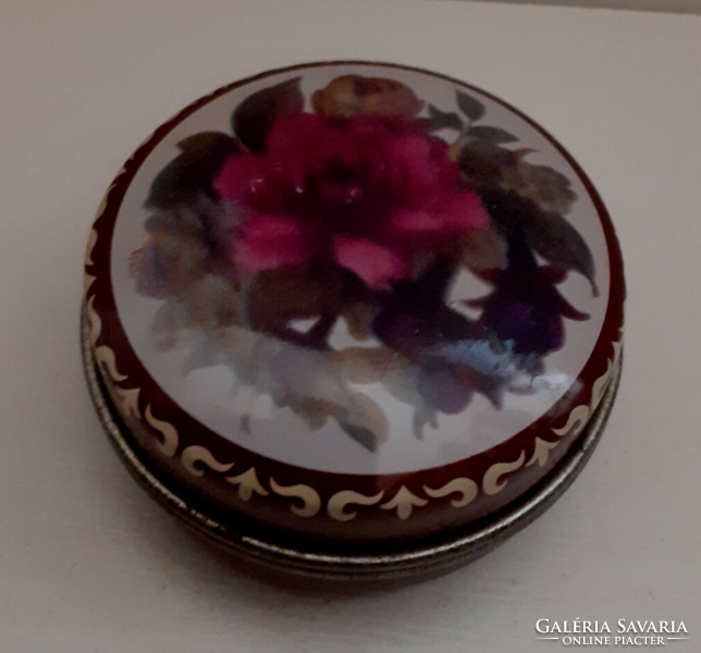 Metal medicated jewelry box with a rose floral pattern on it