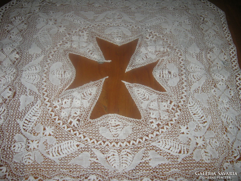 Old lace tablecloth with a cross
