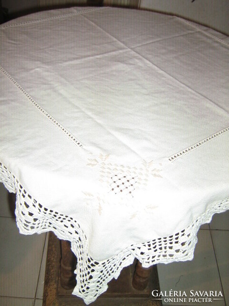 Beautiful azure hand-embroidered antique beige tablecloth with crocheted edges