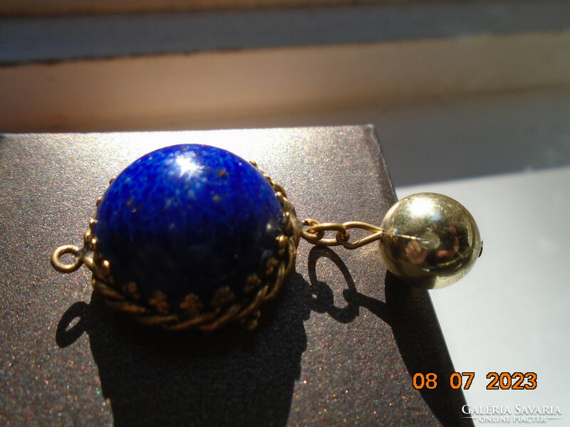 Lapis lazuli hemisphere in a decorative ormolu fire-gilt socket with a gilt sphere