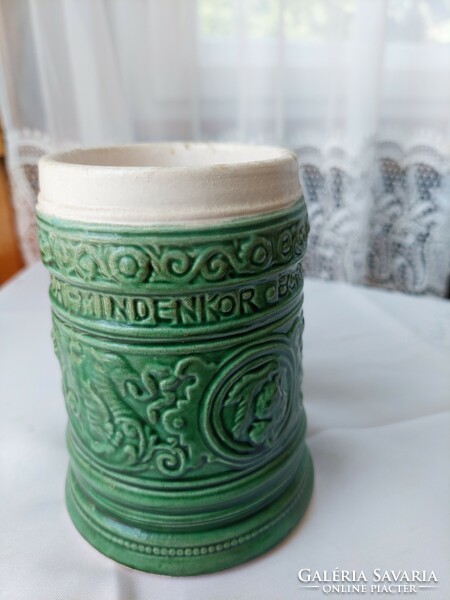 Green cup with an inscription