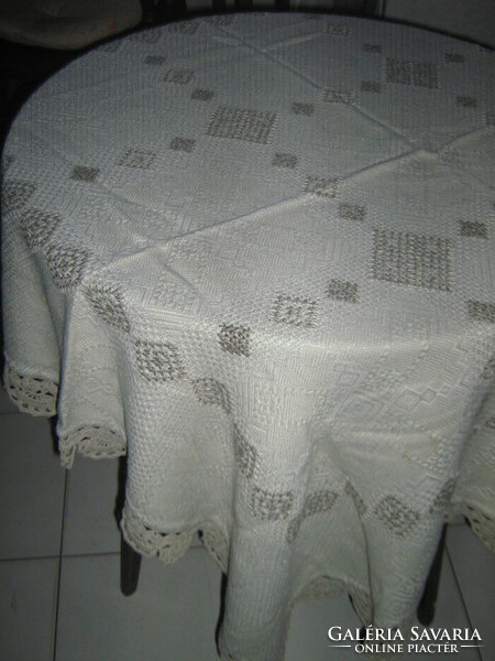 Beautiful antique hand-embroidered woven tablecloth with cross-stitch crocheted edges