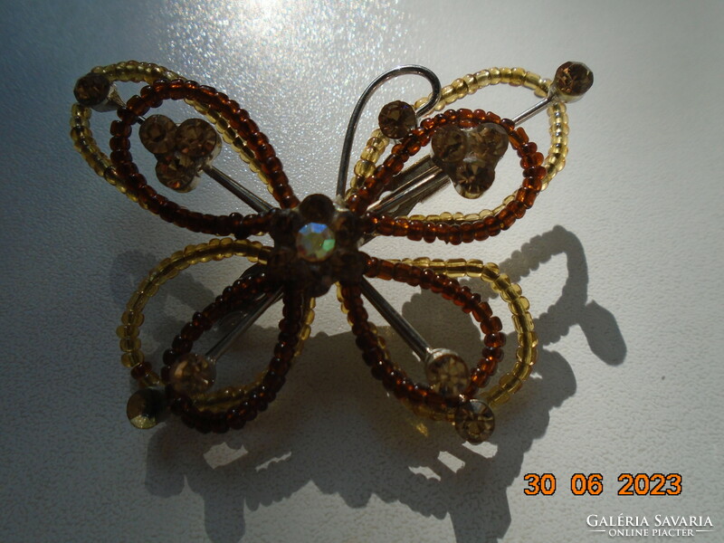 Butterfly brooch made of iridescent cut stones and small amber pearls