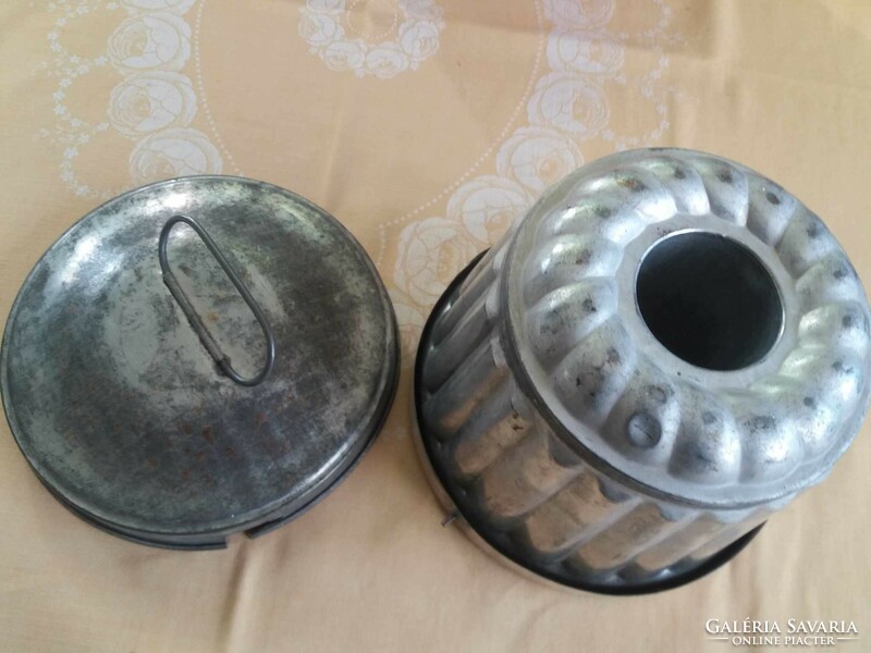 Old metal pudding cooker with a lid
