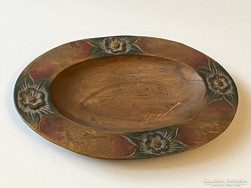 Oval wooden bowl decorated with hand-carved flowers