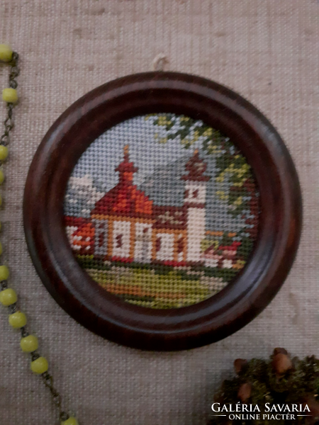 A nun's legacy porcelain rosary small tapestry church in a wood garden with a leaf weight image of the Virgin Mary