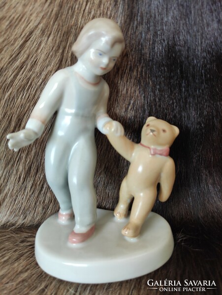 Porcelain statue of a little girl with a teddy bear