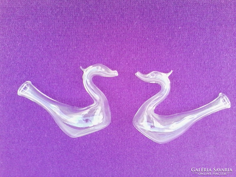 Glass swans in pairs
