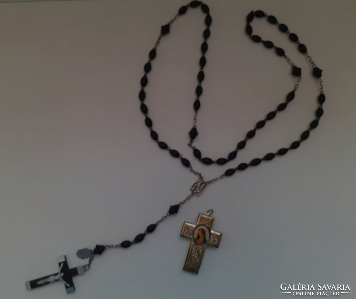 A rosary prayer chain made of old rosewood beads with a crucifix combined with a reliquary holder