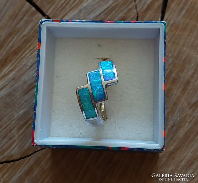 A wonderful silver ring with a synthetic blue opal stone with a beautiful play