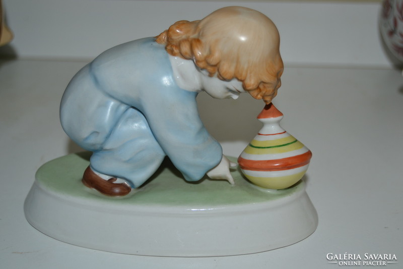 A child playing with a porcelain snail from Zsolnay