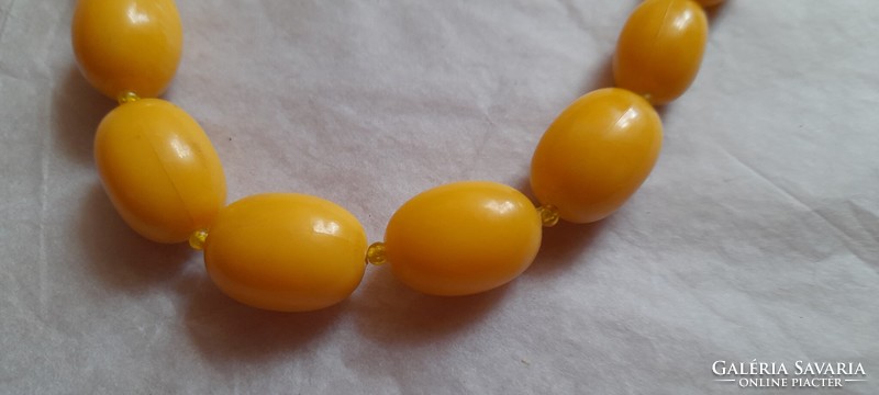 Yellow plastic string of beads, necklace
