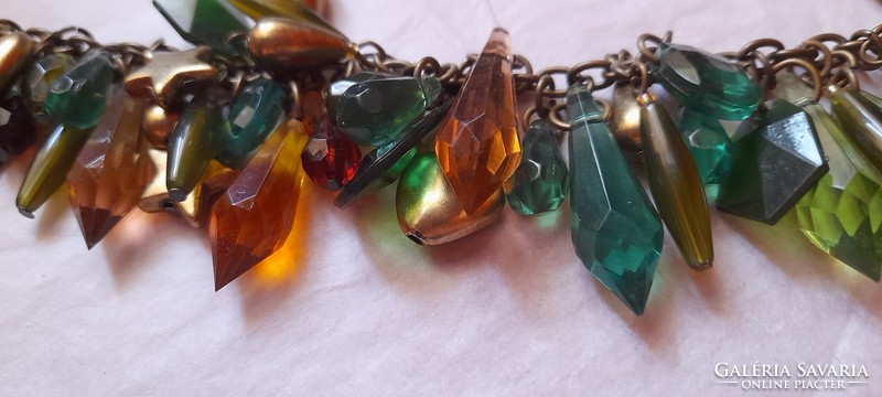 Green-gold bracelet with many pendants with a heart and star motif
