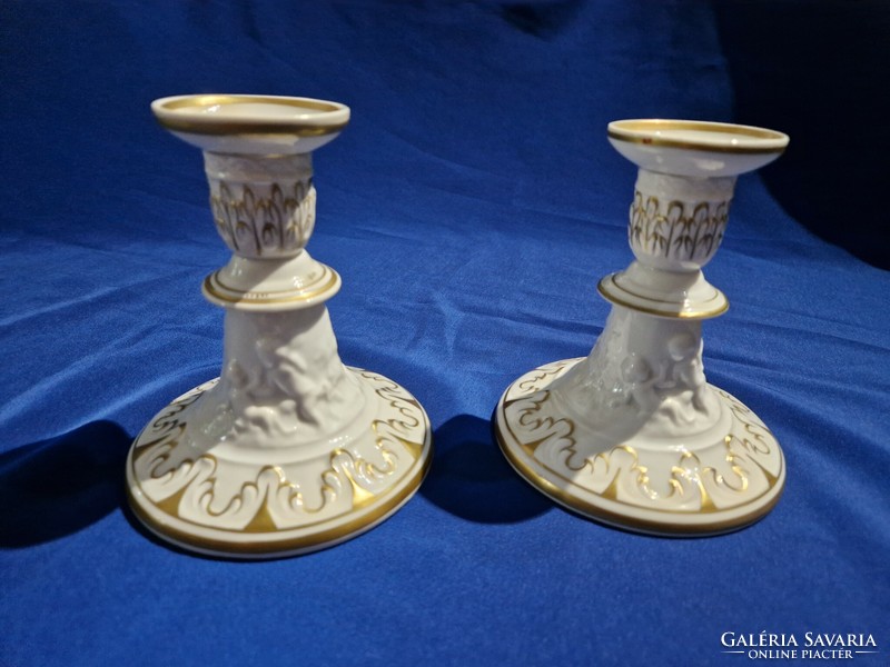 A pair of GDR porcelain candle holders decorated with gilded and embossed patterns