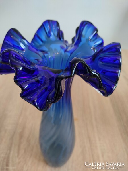 Blue funnel vase made of glass with ruffled edges