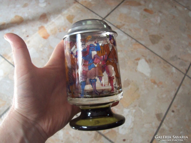 Images of medieval figures on the side of a glass jar with a lid