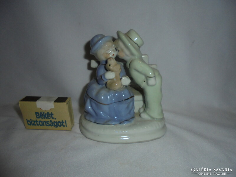 Porcelain nipp, figurine with children giving kisses