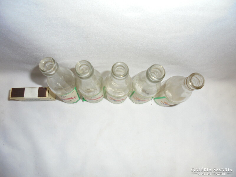 Five old, half-decid, glass bottles with labels, brandy bottles - together - mixed fruit