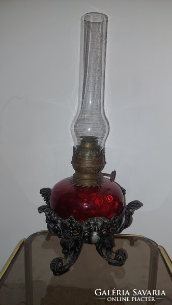 Antique kerosene lamp in crimson color with a larger glass container