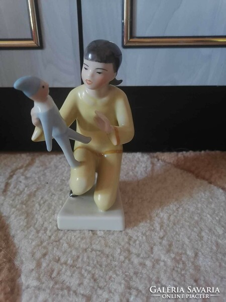 Art deco drasche figurine of a little girl playing with a porcelain doll