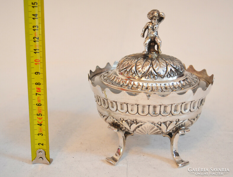 Silver sugar box with a plastic child figure on top
