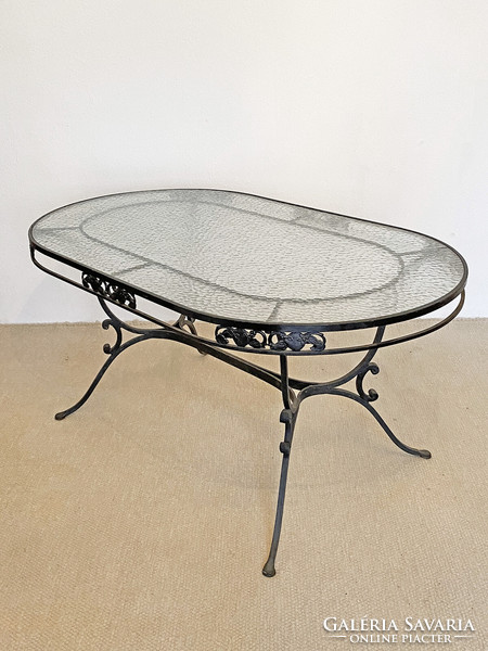 Graceful wrought iron dining table with glass top