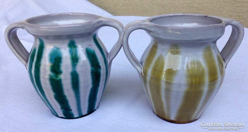 Drapp, green striped ceramic jugs are sold in pairs