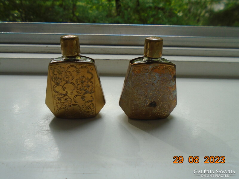 2 perfume bottles in an oriental gilded chiseled flower pattern case, one of which contains 3/4 perfume