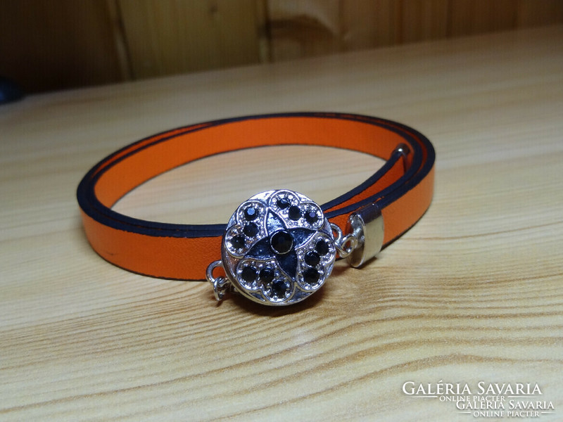 Noosa bracelet made of orange genuine leather, with three rows of matching crystal clasps.