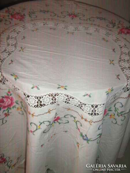 Dreamy pink oval tablecloth embroidered with small cross stitches
