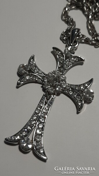 With a beautiful cross chain studded with large crystals