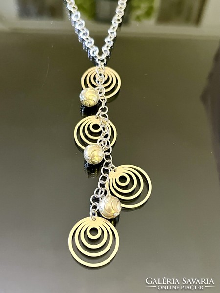 A beautiful silver necklace with a gold-plated pendant