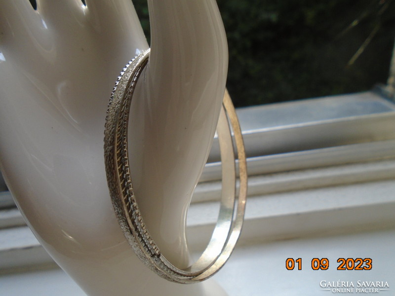 Two silver-colored embossed bracelets