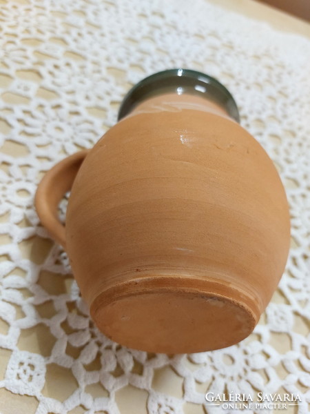 An old mug, a glazed earthenware pot, a jar, a jug, a tumbler